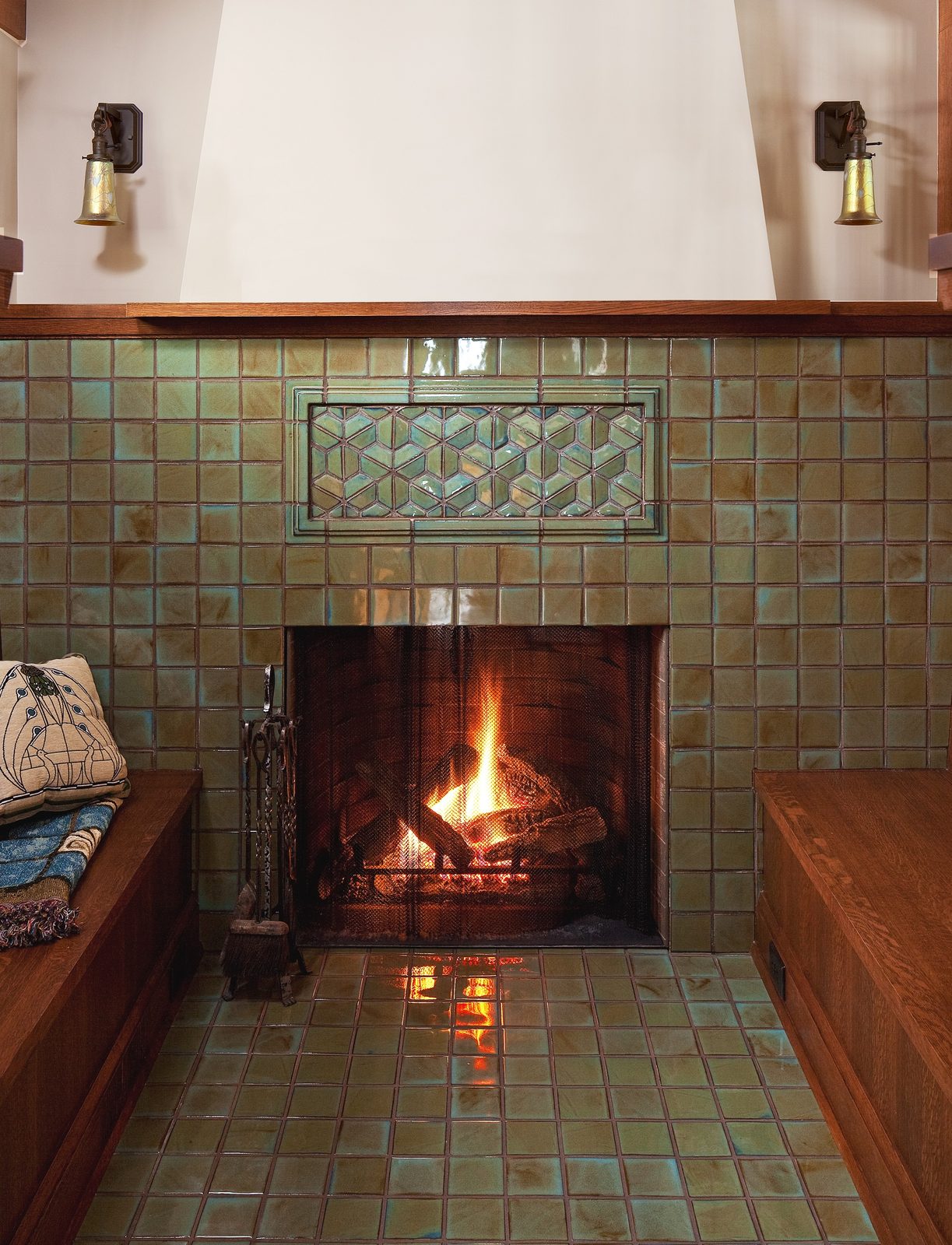 Inglenook fireplace in green handmade tile with oak benches