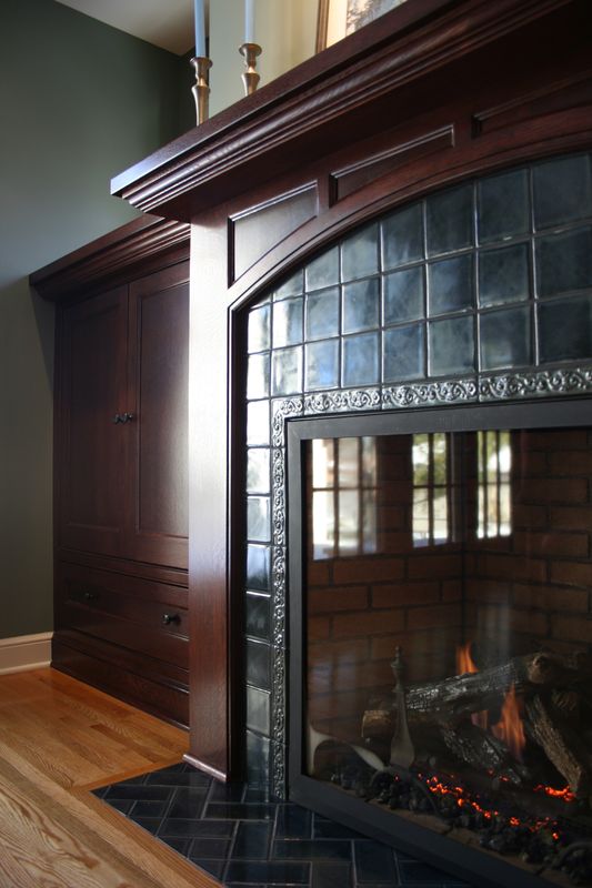 Fireplace in deep blue gloss tile with dark wood mantel