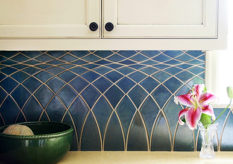 Kitchen backsplash in blue Prairie Lattice tile under cream cabinets