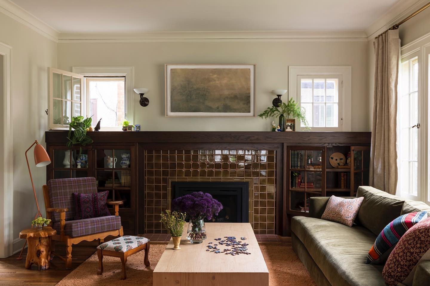 Living room fireplace in brown gloss square tile with built-in bookcases